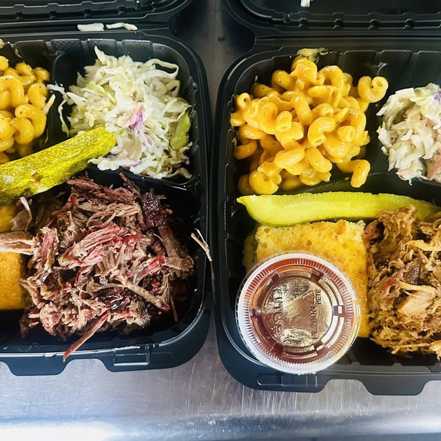 A loaded plate — smoked meat, mac, beans and cornbread