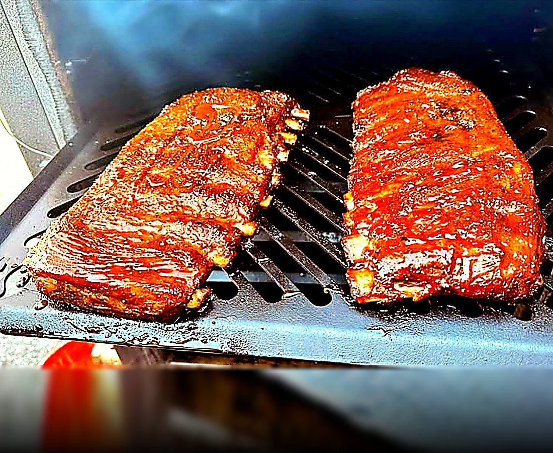 Two racks of glazed pork ribs on the truck’s grill